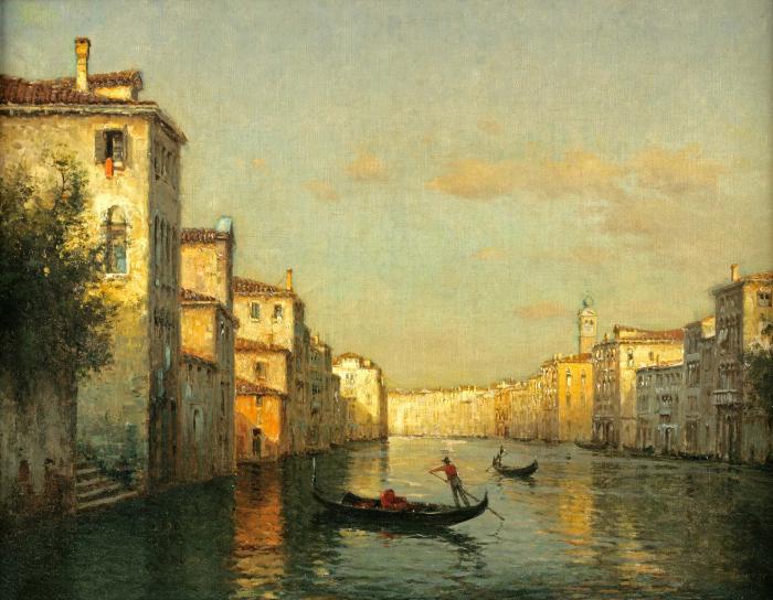 A view of a Venetian canal with gondolas in the foreground